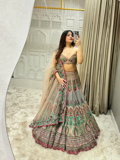 I call this my 'Unicorn Lehenga' and you can see why. The unique blend of pastel grey, pink, and green threadwork creates a magical, one of a kind look for a bride who wants something different. This designer piece is available to rent or buy.