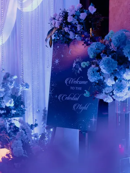 The welcome signage for the "Celestial Night" Sangeet, surrounded by blue-toned florals and dreamy lighting.