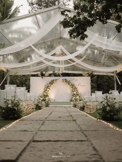 An evening reception under the stars, encased in a beautifully draped clear tent. I focus on creating ambiance, using lighting and elegant florals to craft a romantic, intimate setting for you and your guests to celebrate in style.