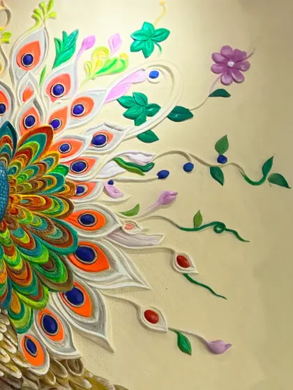A close-up detail of the peacock mural, focusing on the fanned-out tail feathers and the delicate, colorful flowers that surround it.