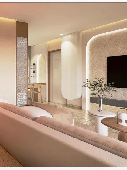This living room is designed to feel like a warm embrace, with sunlight casting golden whispers across the space. The design uses soft textures, curved furniture, and a palette of warm neutrals to create a serene and peaceful atmosphere. An arched niche and textured walls add architectural interest and depth.
