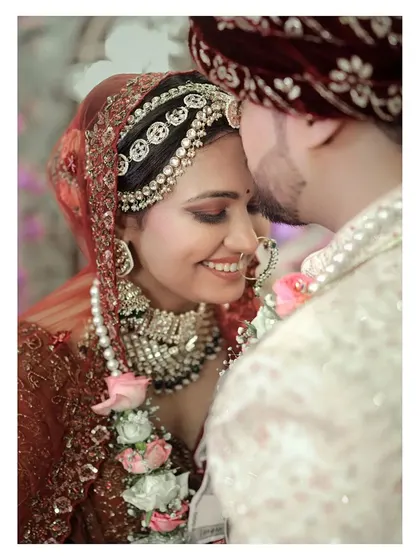 A close-up of the couple, capturing the bride's happy smile and the groom's loving gaze.
