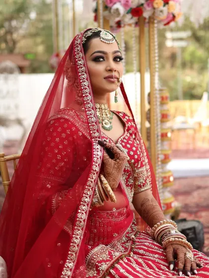 A side profile showcasing the complete styling. The makeup, hair, and dupatta are all harmonized to create a look of pure elegance.