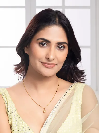 A portrait of the model wearing the delicate gold necklace, capturing a warm and gentle expression. This style of image helps to create an emotional connection with the product.