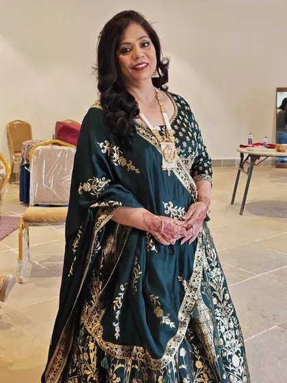 A full-length view of the groom's bua, looking absolutely regal. I provided makeup, hairstyling, and draping to complete her look for the destination wedding.
