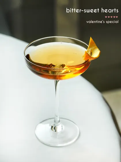 For Valentine's, we created the "Bitter-sweet Hearts" cocktail. This elegant drink, with its delicate orange peel garnish, was part of a special menu designed to celebrate romance with bold and playful flavors.
