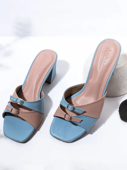 This stylish shot of pastel colored block heels uses soft lighting and subtle shadows. The composition is clean and contemporary, highlighting the shoes' modern design and color combination.