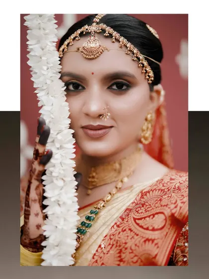 A beautiful close-up of a bride, her face partially obscured by a garland of white flowers.