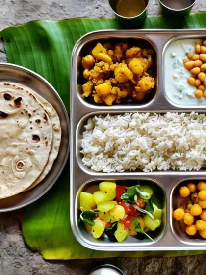 This compartmentalized thali keeps every dish distinct and flavorful. It features rice, two different dry sabzis, a chickpea salad, raita, and rotis, showcasing the variety I offer.