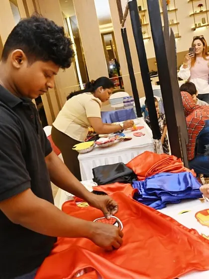 A little hero getting his cape customized at one of our creative stations.