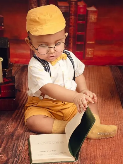 Getting lost in a good book. This pose is perfect for showing a baby's curiosity, even if they are just exploring the pages with their hands.