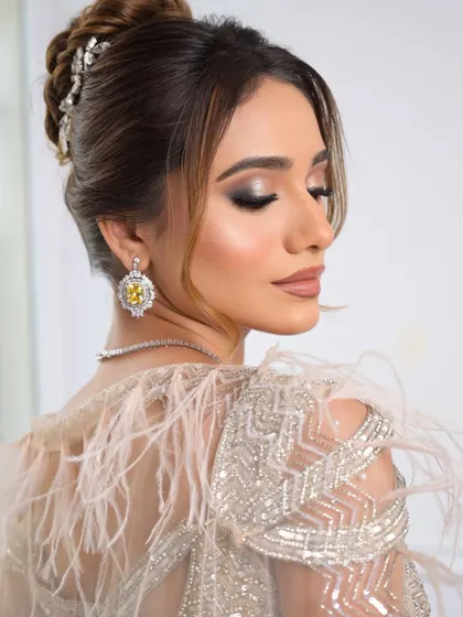 A beautiful portrait focusing on the flawless makeup and the intricate details of the hairstyle.