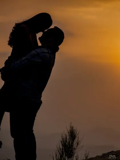 A perfect silhouette against the golden hour sun, capturing the pure romance and intimacy of a couple's connection. I live for these magical sunset moments in the hills.