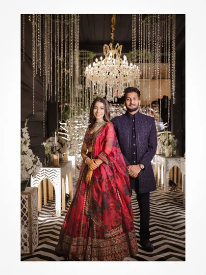 A classic portrait of the couple at their beautifully decorated Sangeet or Reception stage.