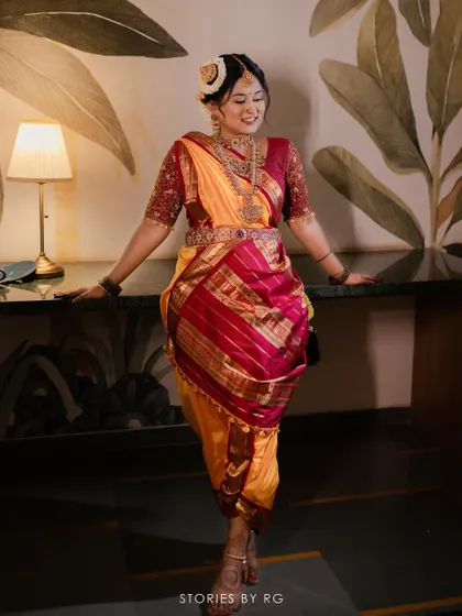 This bride glows with timeless beauty in her Madisar saree. The makeup is traditional, with defined eyes and a classic bindi.