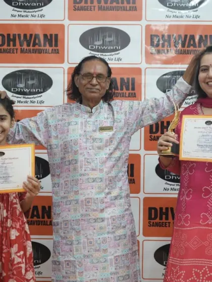 A mother and daughter duo celebrate their awards with their guru.