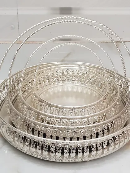 This set of nesting German silver trays is both practical and beautiful. The intricate latticework and sturdy handles make them perfect for serving guests or as a base for a decorative arrangement.