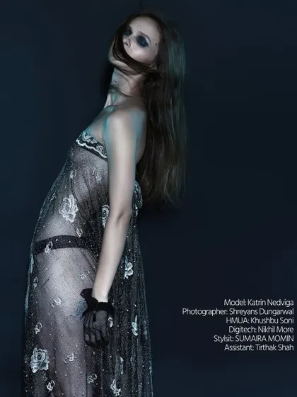 A full-length shot showing the entire look from the "Raw Reverie" series. The lighting is minimal, focusing on the silhouette.