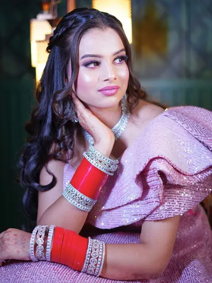 A close-up of the pink sequin gown, highlighting the traditional red chooda for a fusion look.