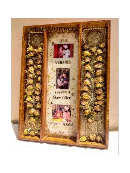 A full view of a large, three-panel varmala preservation frame. This design allows for the entire garlands to be laid out beautifully, with a central panel for photos and personalized text.