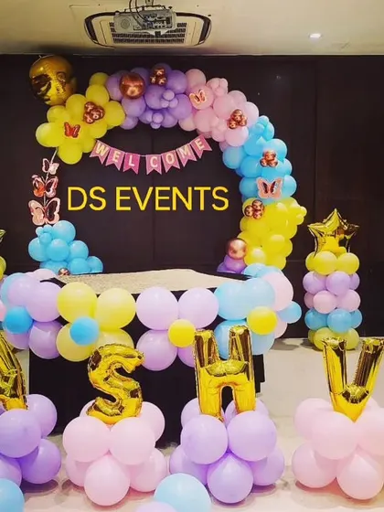 A personalized naming ceremony for baby Kashvi. This butterfly-themed decor uses pastel balloons and custom letter balloons to create a sweet and welcoming atmosphere for the family's newest member.