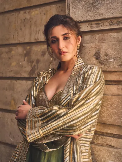 This pose exudes confidence. It shows how the right outfit can empower you, blending traditional elements with a strong, modern attitude.