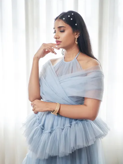 The 'Diana' gown is all about elegant versatility. This photo shows the detachable off-shoulder sleeves, which can be added to the halter-neck base for a layered, romantic look.