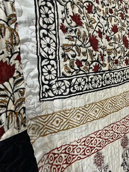 Detail of the border work on a custom saree quilt, highlighting the original block-printed patterns.