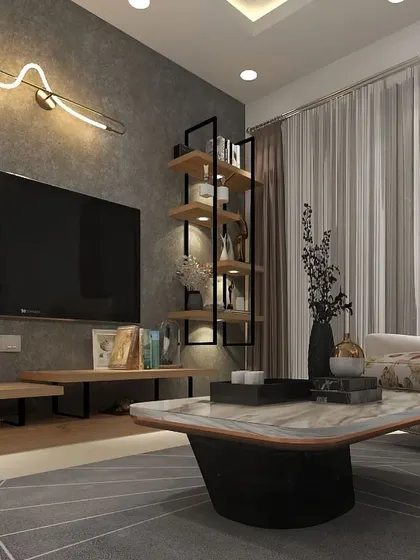 A cozy corner of a living room, featuring a modern TV console, an industrial-style bookshelf, and a comfortable armchair. The unique wall sconce adds an artistic touch to the space.