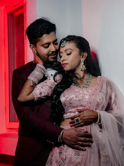 A romantic embrace between the couple, captured with dramatic lighting.