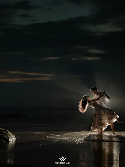 A romantic dance on the shore as twilight sets in. The dramatic lighting and the vastness of the ocean create a truly cinematic and unforgettable pre-wedding portrait.