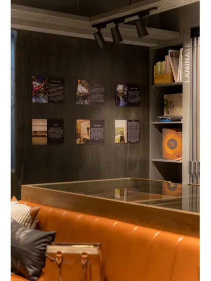 A gallery wall within the showroom displays photos and information about different projects, providing context and inspiration.