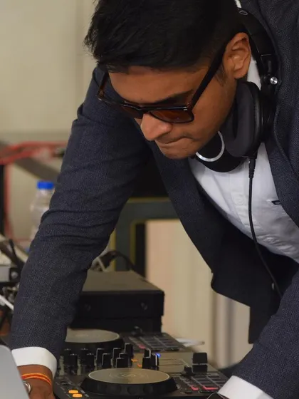 Focused on the mix during a lively wedding party. I'm constantly adjusting levels and blending tracks to maintain a smooth flow of energy on the dance floor.