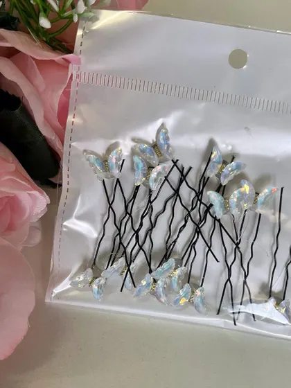 For a classic and elegant look, you can't go wrong with these white iridescent butterfly U-pins. They look stunning on dark hair.