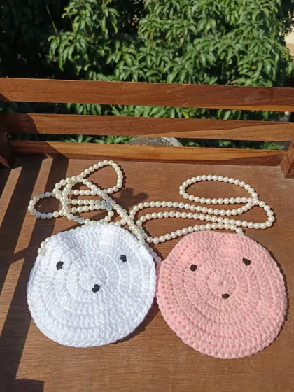 Adorable round sling purses with cute faces and pearl straps. I can make these in a variety of colors for bulk orders.