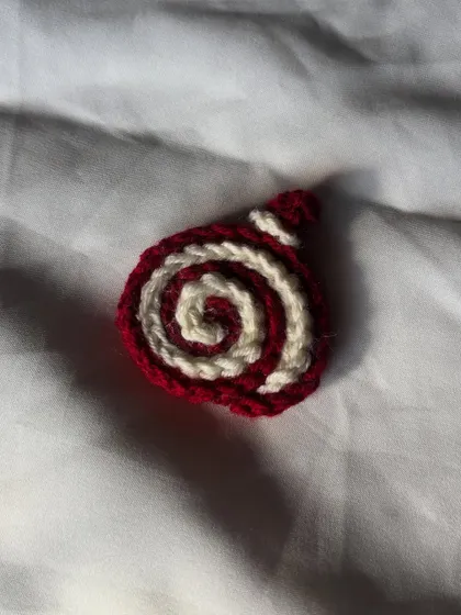 A close-up of the red and white crochet cake roll. This one reminds me of red velvet cake.