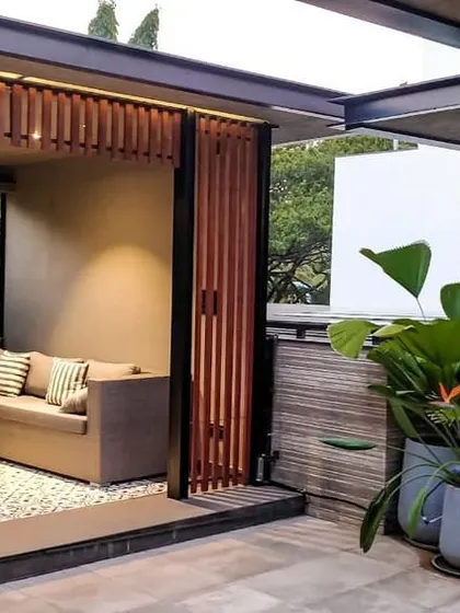 This shot highlights the material palette of the Chhabria's Terrace, with wooden screens, large grey planters, and patterned floor tiles that define the sophisticated and modern aesthetic.