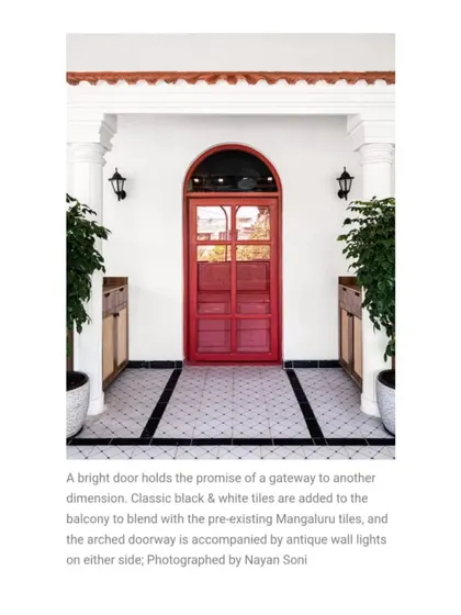 This shot from our Elle Decor feature captures the promise of the bright red door. Accompanied by antique wall lights, it serves as a bold statement piece at the entrance.