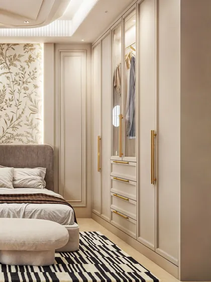 This shot focuses on the elegant wardrobe with its glass-fronted display section and brass handles.