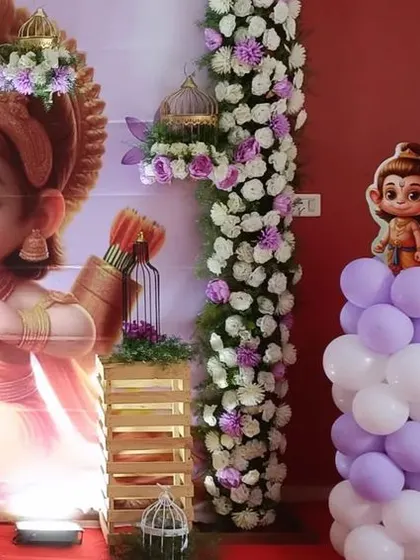 A closer look at the details of the Ram-themed naming ceremony. The character cutouts of Hanuman and Krishna add a playful and divine element to the decor.