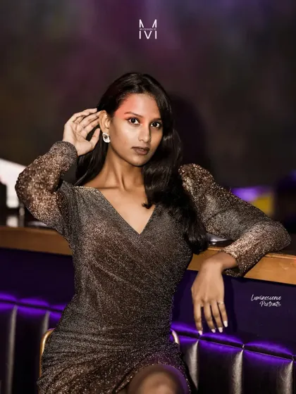 A direct and engaging portrait, the model looks at the camera with a confident expression, perfectly at home in the stylish club setting.