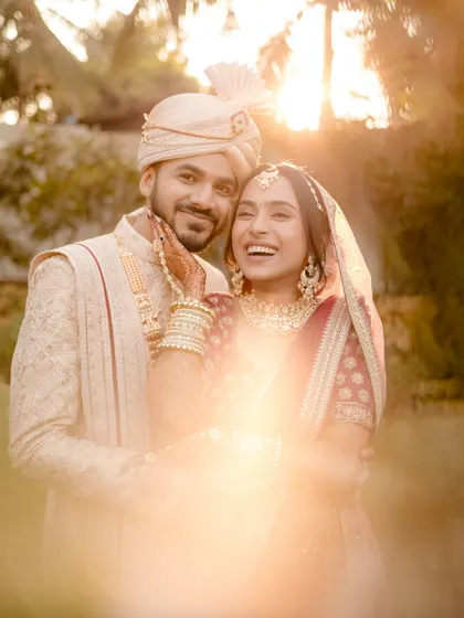 A golden hour portrait that glows with warmth and love. The lens flare adds a dreamy, magical quality to this happy couple's embrace.