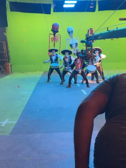 Here you can see the technical setup with a camera crane and green screen. I choreographed this sequence for a group of male models, incorporating props and puppetry into the performance.