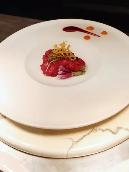 A dish that is a true work of art. The vibrant red of the main element is complemented by a delicate tuile and artistic sauce work, demonstrating our "designed, not dished" philosophy.