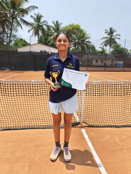 Manvita Rajendra proudly displaying her runner-up trophy and certificate from the Under 16 AITA All India Championship Series National Level Tournament.