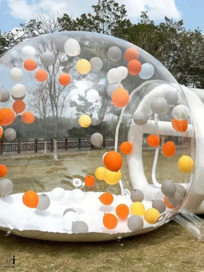 A transparent bubble house filled with colorful balloons. Kids can play inside this unique inflatable, which also serves as a fantastic piece of interactive decor.