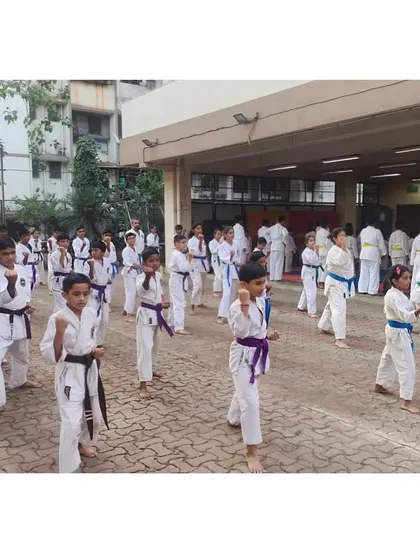 Students lined up and practicing their forms outside the dojo. We utilize different environments to make our training adaptable and dynamic.