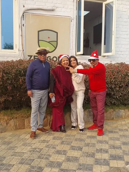 A family gets into the holiday spirit, posing for a photo in their festive red attire outside our clubhouse during Christmas.