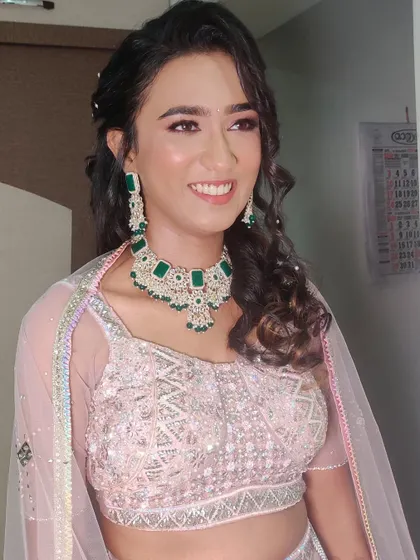 A dreamy, princess-like makeover for Ankita's Sangeet, with glowing skin and a messy ponytail.