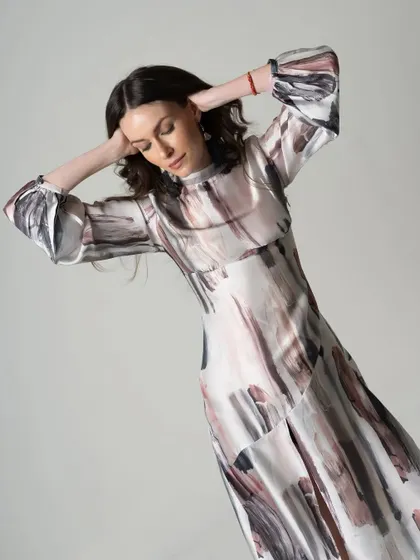 A fashion catalogue image capturing the flow and pattern of a printed dress. Movement is used here to show the fabric's texture and how it drapes.
